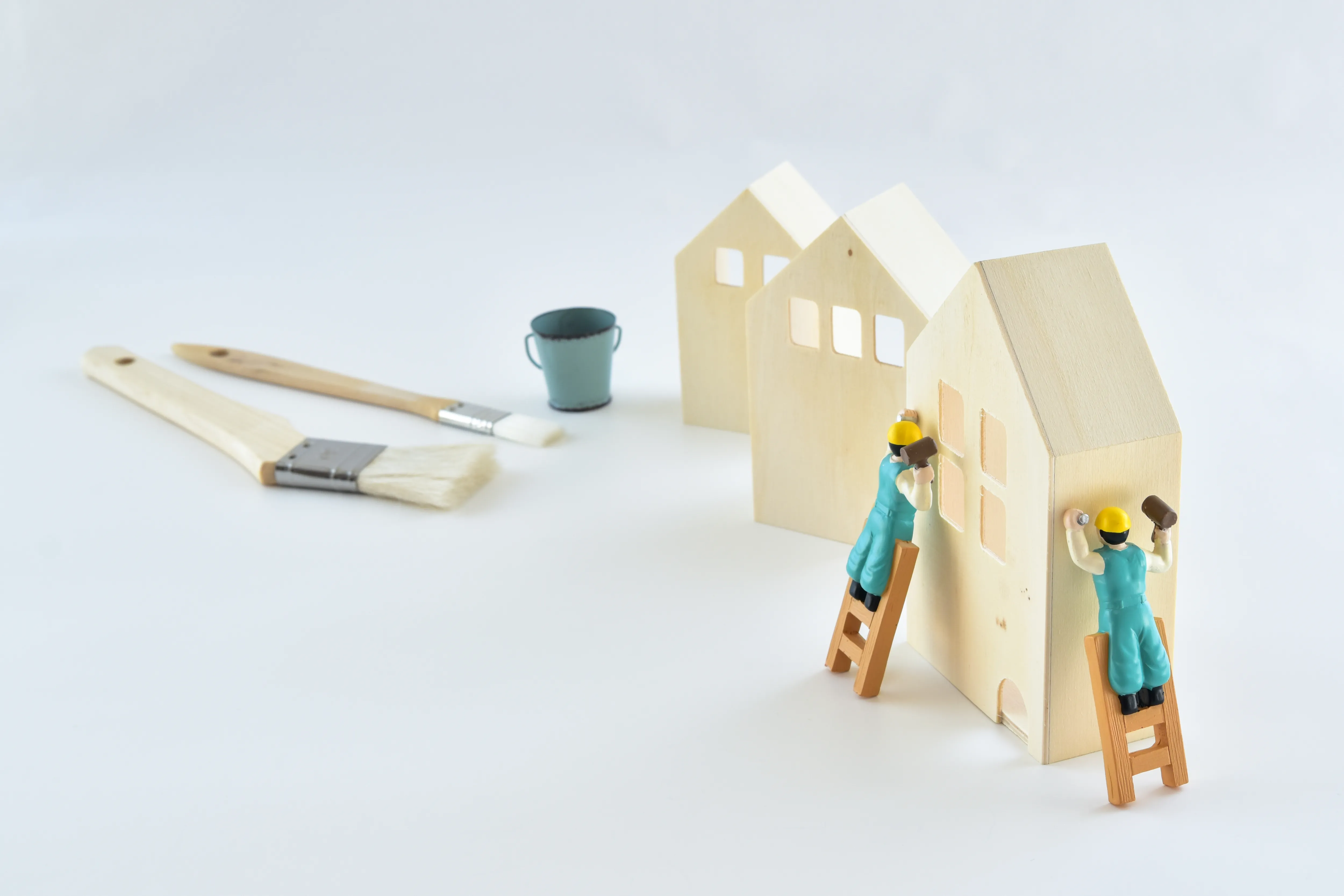 住宅の模型と刷毛で表した塗装のイメージ