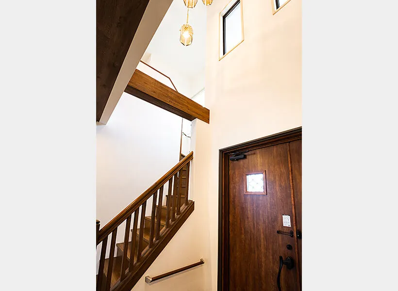 頭上のシャンデアが印象的な吹き抜け玄関と階段